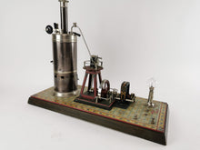 Load image into Gallery viewer, Bing steam engine with dynamo on a decorated tin and wood base | 1.549€
